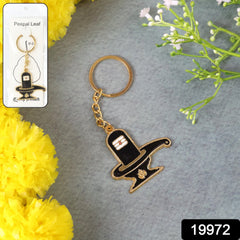 Close-up of the intricate Shivling design on the golden keychain