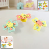 Buzzy Baby Spinner Toy Set with suction cup on flat surface