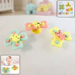 Buzzy Baby Spinner Toy Set with suction cup on flat surface