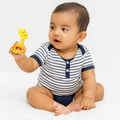 Close-up of a baby holding a star-shaped rattle
