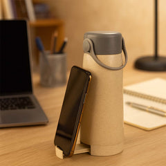 Close-up of glass bottle with phone holder attached