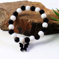 Designer style black and white bracelet with cross charm