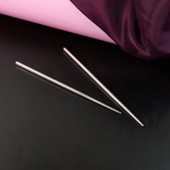 Snack sticks held by stainless steel chopsticks