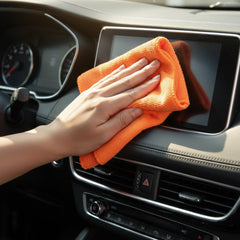 Cleaning cloth wiping a glass surface streak-free