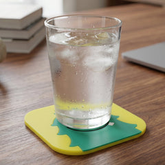Colorful cartoon monster silicone coasters protecting table surfaces.