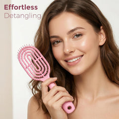 Person holding pink curved detangling hair brush