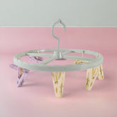 Clothespin rack with 8 clips hanging laundry items
