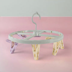 Clothespin rack with 8 clips hanging laundry items
