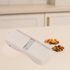 Dry fruit and ginger slicer showing slicing action