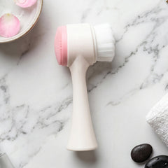 White and pink dual-sided facial cleansing brush for gentle skin cleansing