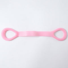 Woman using a silicone resistance band for arm exercises