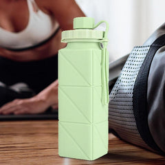 Folding water bottle shown in use