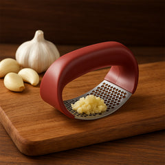 Supermom Kitchen Garlic Press in use on garlic cloves