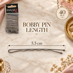 A single grey metal bobby pin is displayed horizontally, showing its 5.5 cm length measurement on a marble surface.