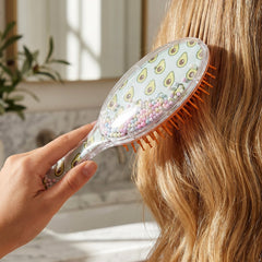 Hair brush showing cushioned base for scalp massage