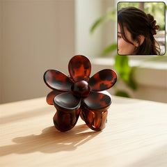 Elegant plastic flower hair clip on white background