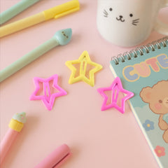 Girl wearing colorful star hair clips in her hair