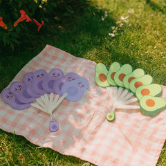 Handheld foldable fan being used
