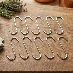 Close-up of a silver S-shaped hook hanging over a rod.