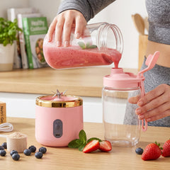 Close-up of pink portable juicer blades crushing fruits