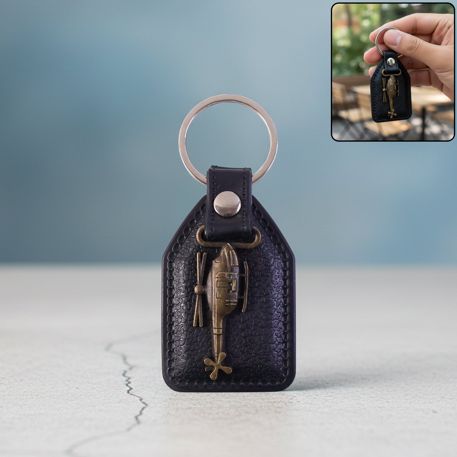 Premium leather finish keychain with metal sword emblem front view