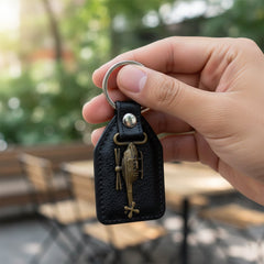 Back view of leather and metal sword keychain