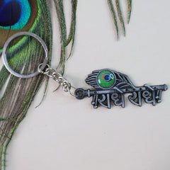 Religious Radha Krishna metal keychain on display