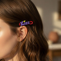 Two 'Kiss' hair clips styled in long brown hair