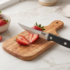 Steak knife slicing through cooked meat