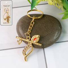 Flute and Peacock Feather Krishna metal keychain on white background
