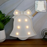 Bell Shaped LED Decorative Night Light glowing pink on table