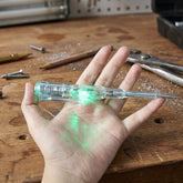 Digital voltage tester pen in use on an electrical outlet