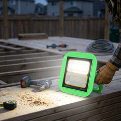 Mounted outdoor LED flood light illuminating garden area