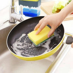 Soap dispenser filled with dish soap and sponge in holder