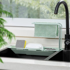 Telescopic sink caddy rack holding kitchen cleaning supplies