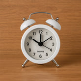 Small twin-bell analog alarm clock face