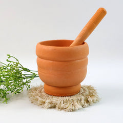 Mortar and pestle set with pestle resting in mortar