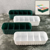 Four 5-compartment drawer organizers stacked with various items like socks and underwear