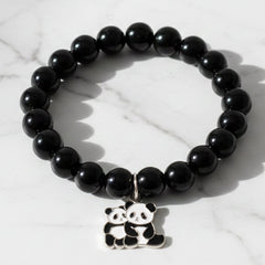 Black beaded stretch bracelet with panda charm on a white background