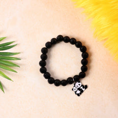 Black beaded bracelet with panda charm on a wrist