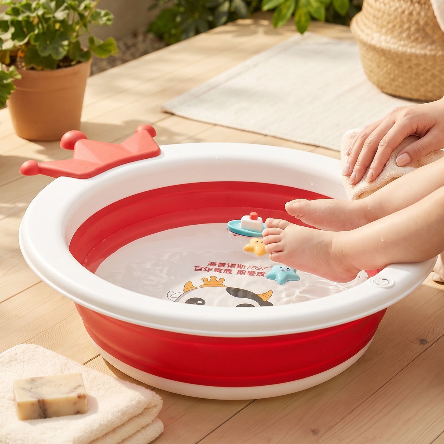 Foldable baby bathtub with non-slip base showing crown and cow face design