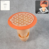 White plastic shower drain cover with hair catcher