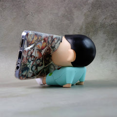 Mobile phone stand with cartoon figurine design