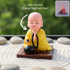 Yellow solar powered sitting Buddha statue with moving head