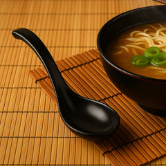 Side view of black plastic soup spoon