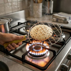 Round steel roaster grill resting on kitchen surface