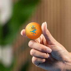 Orange 3-star ping pong balls on a table