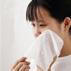Folded compact disposable travel towel