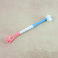 Baby tongue cleaner showing both brush and scraper ends