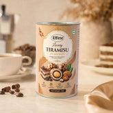 A tall, cylindrical tin of Effete Luxury Tiramisu Almonds sits on a white counter with coffee items.